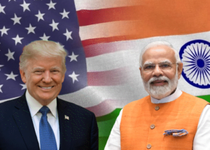 A composite image featuring Donald Trump and Narendra Modi side-by-side against a background of the United States and Indian national flags merged together.